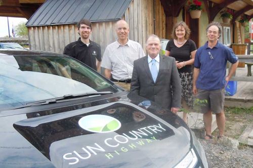 L-r, Paul Camiré, Peter Manson, Reeve/Warden Keith Kerr, Therese Steenberghe and Jeroen Kerrebijn celebrate the new EV charging station at the Fall River Restaurant in Maberly
